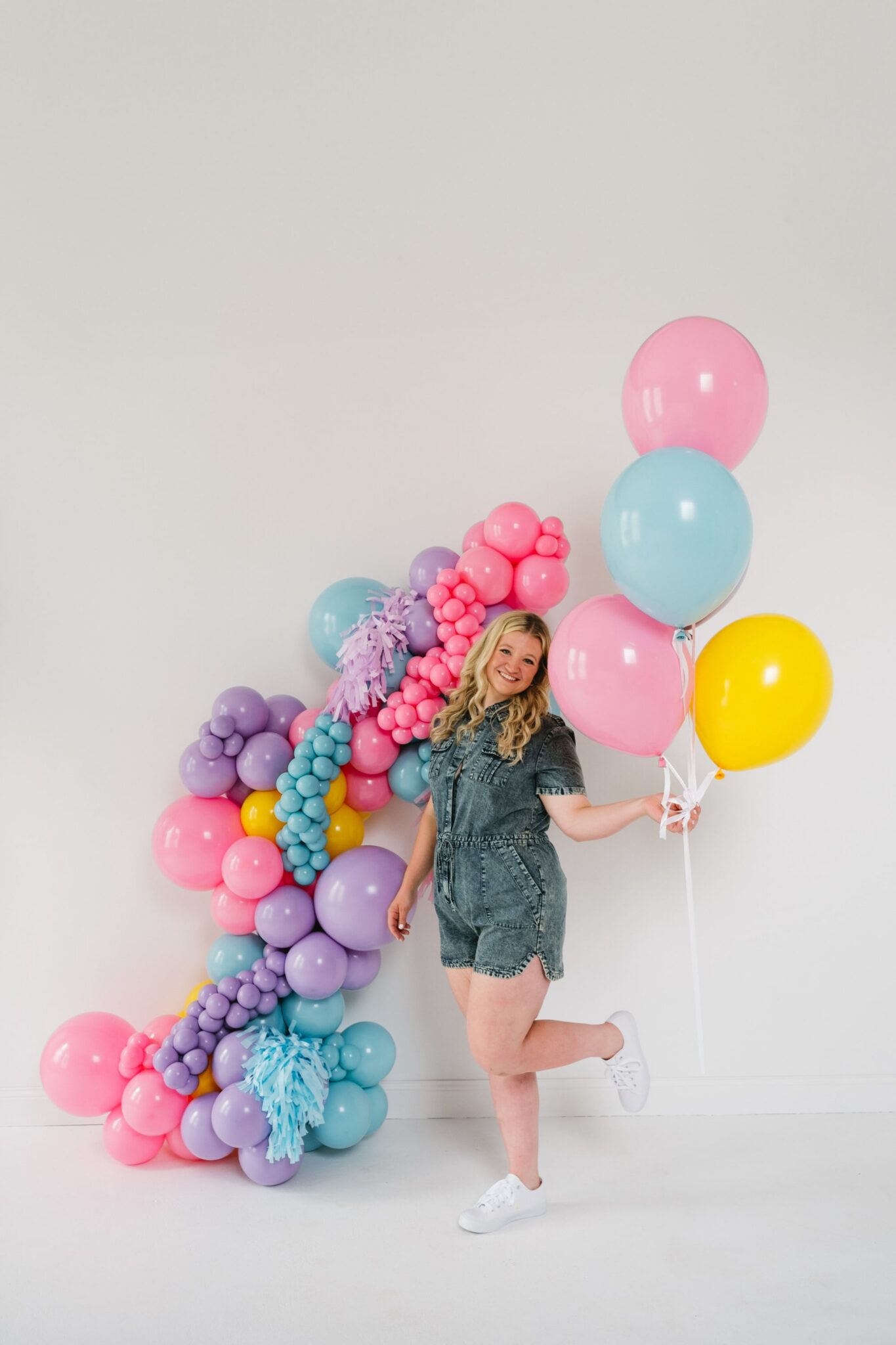KU Balloons owner holding a pastel balloon bouquet during her brand shoot
