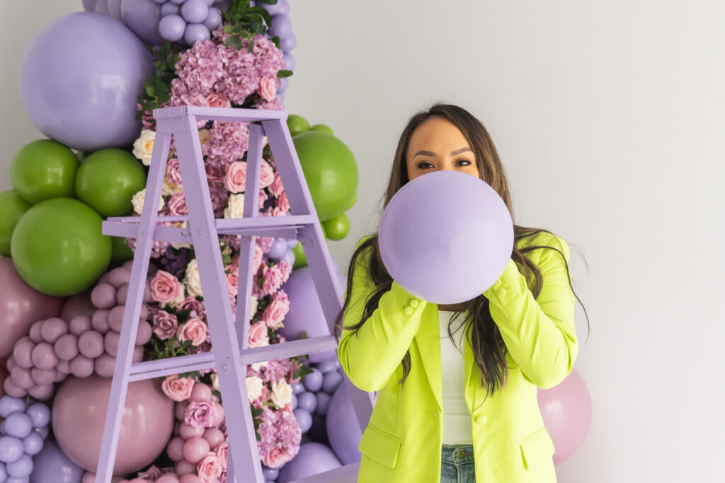 balloon brand shoot woman blowing purple balloon subtle flex