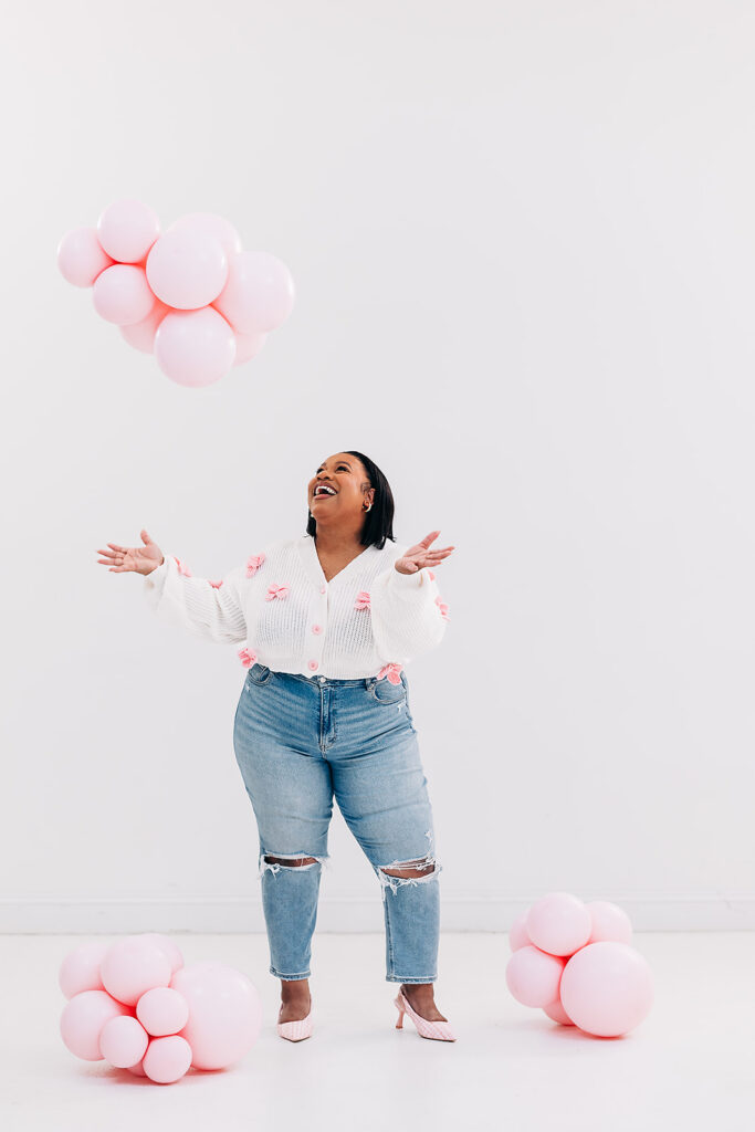 Lauren of Balloré celebrating with pink balloons during her brand photoshoot